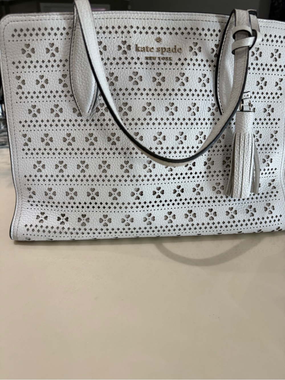 kate spade white perforated leather tote with tassel